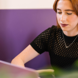 Image of a person working on their laptop