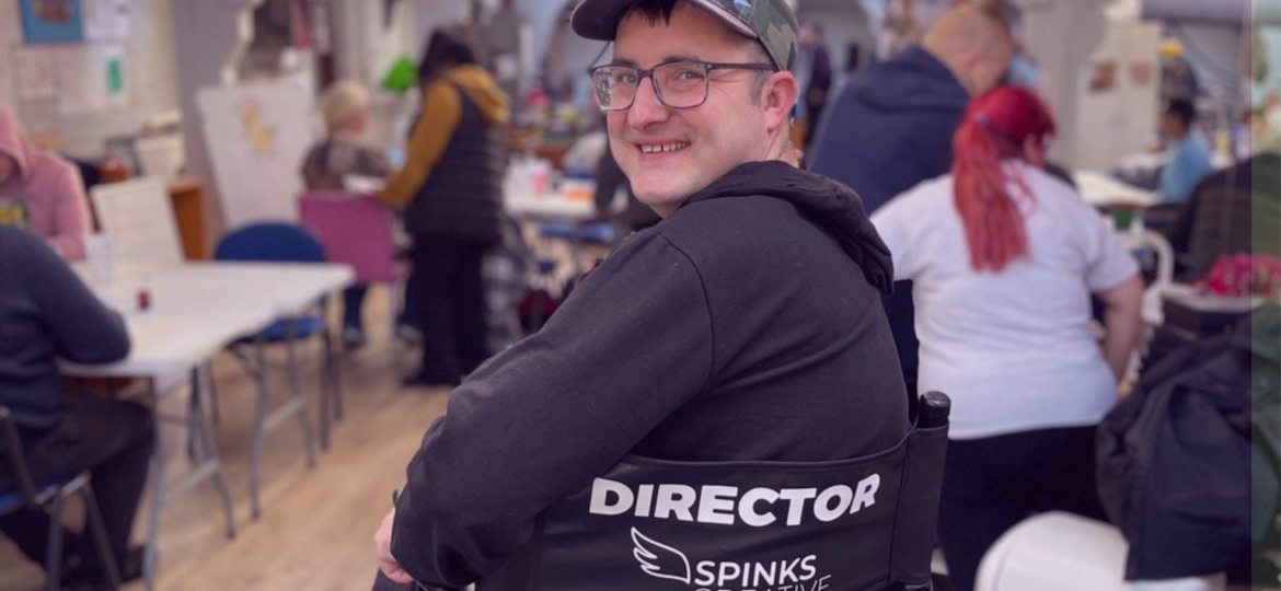 A photograph of a man on a Spinks Creative Directors Chair