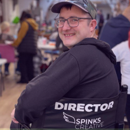 A photograph of a man on a Spinks Creative Directors Chair
